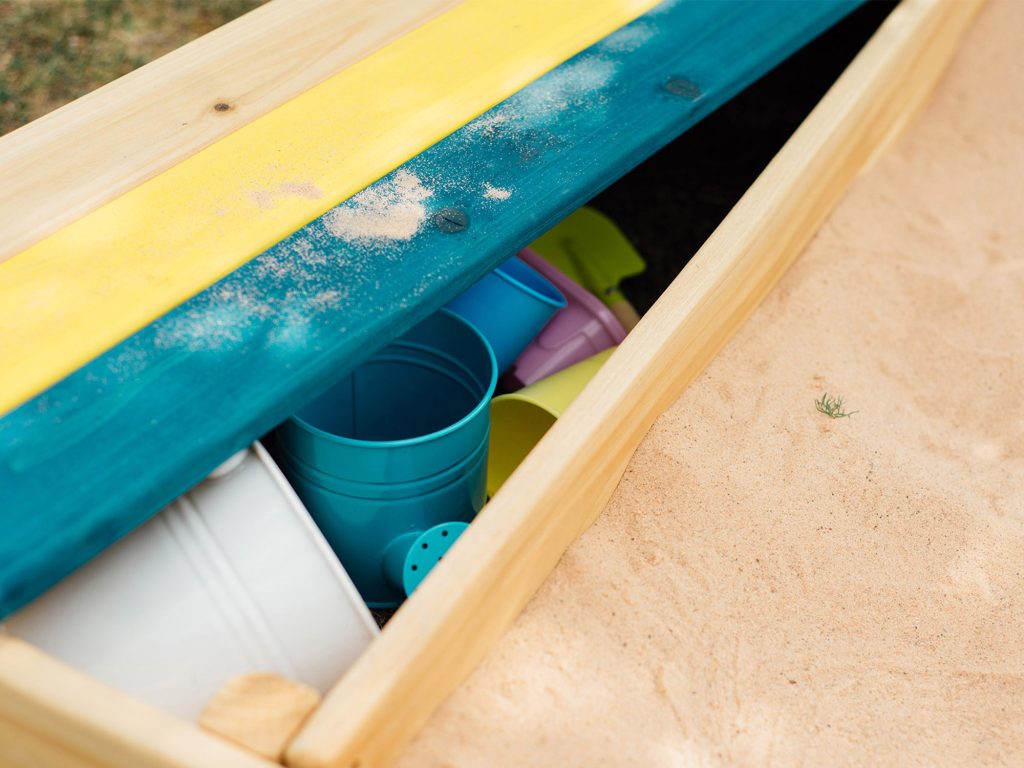 Close up of the Plum Store-It Wooden Sandpit Storage Compartment 