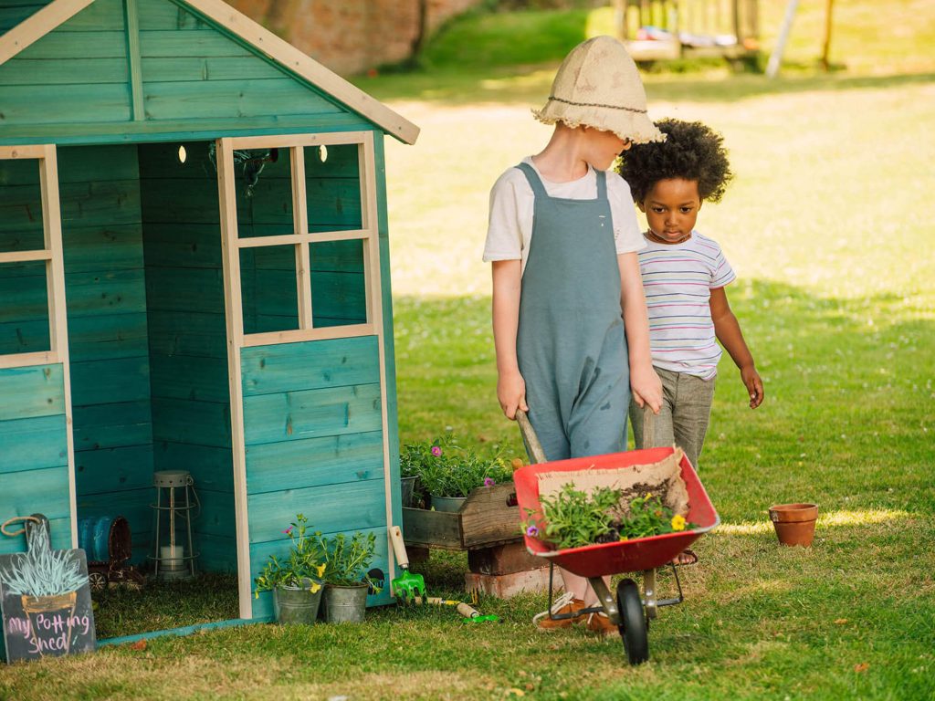 children gardening with wheelbarrow