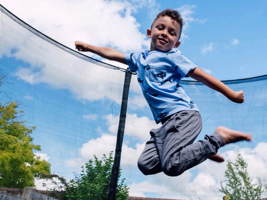 Child jumping on trampoline