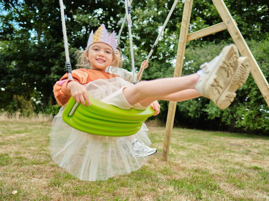 Girl on swing with crown 