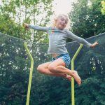 Girl jumping on Plum Play Wave Trampoline