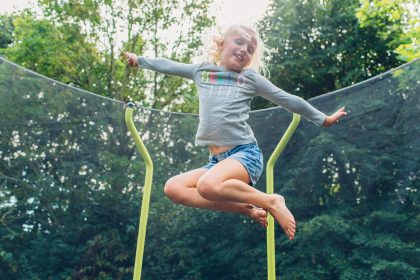 Girl jumping on Plum Play Wave Trampoline